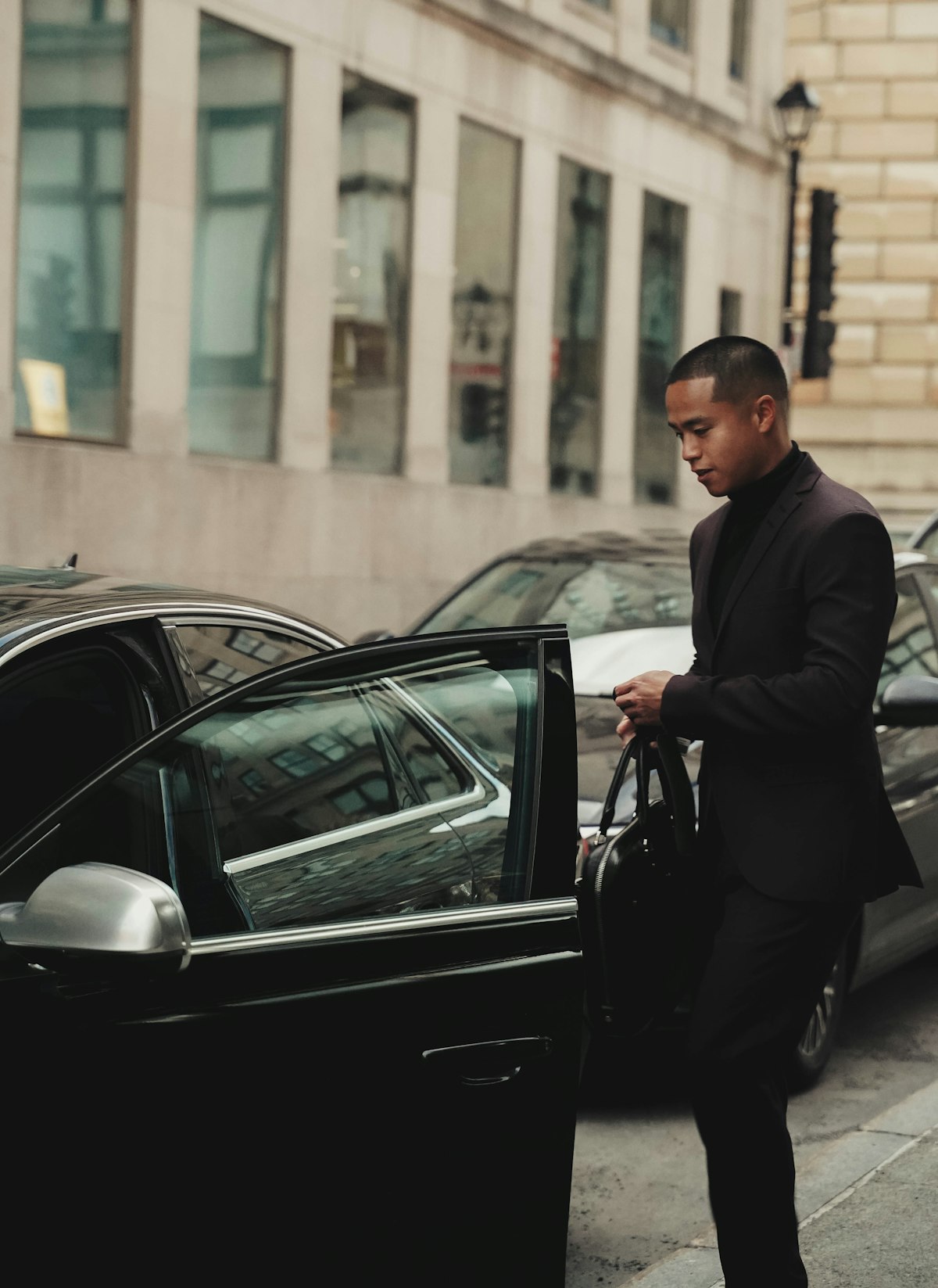 Executive exiting a black SK Limo vehicle